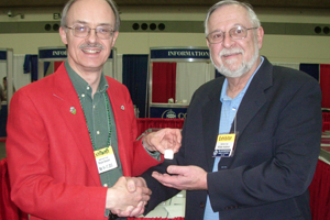 Third place award accepted by William Anderson from exhibit chairman Bryce Doxzon,